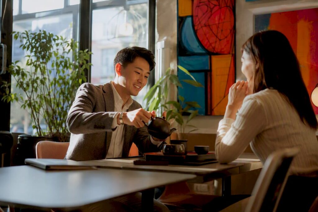 Man pouring tea during business meeting